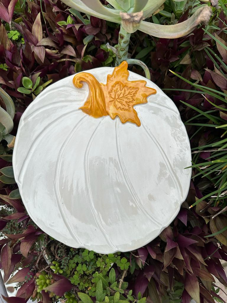 White pumpkin with golden yellow leaves