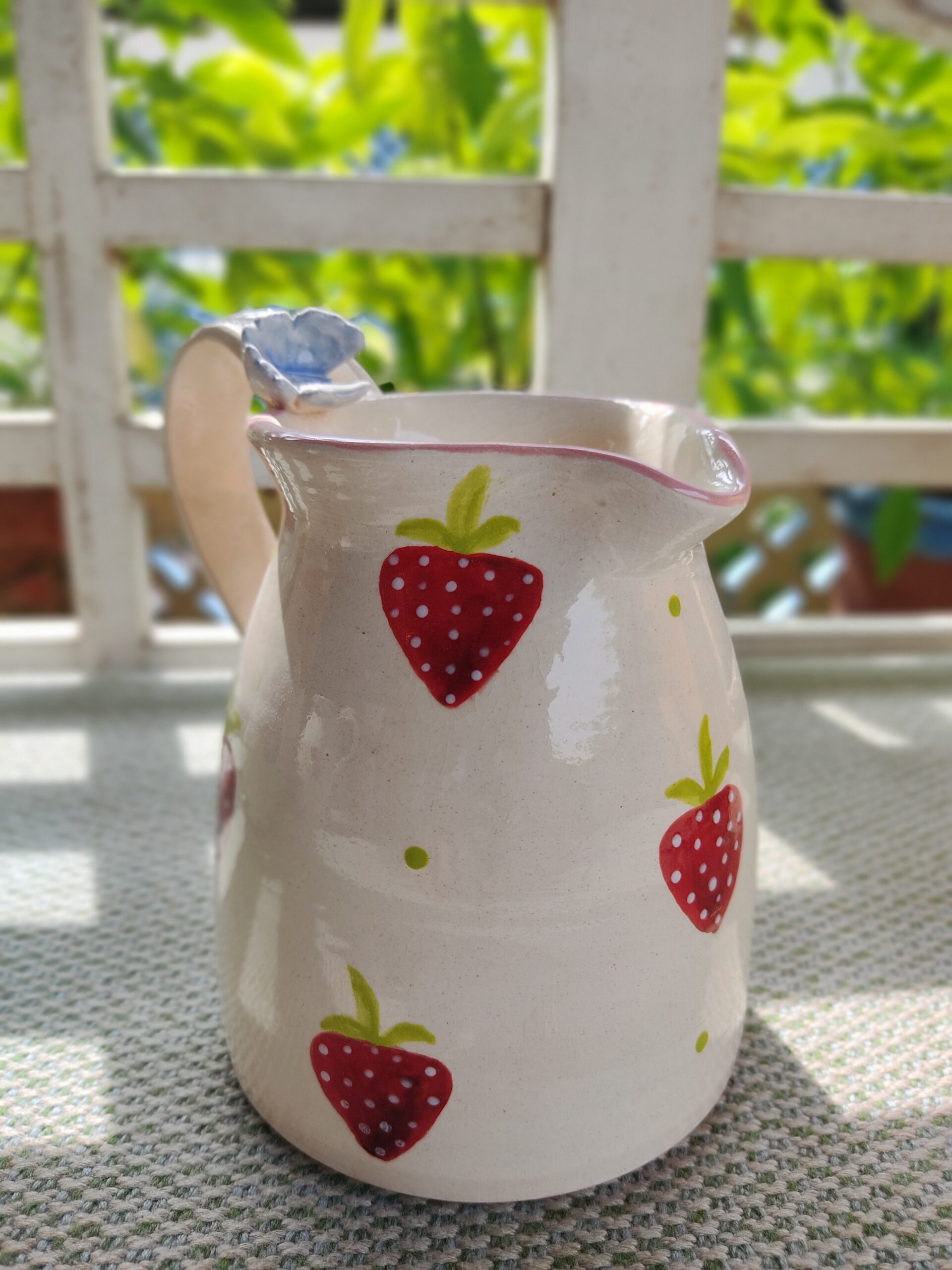 Strawberry jug with butterfly