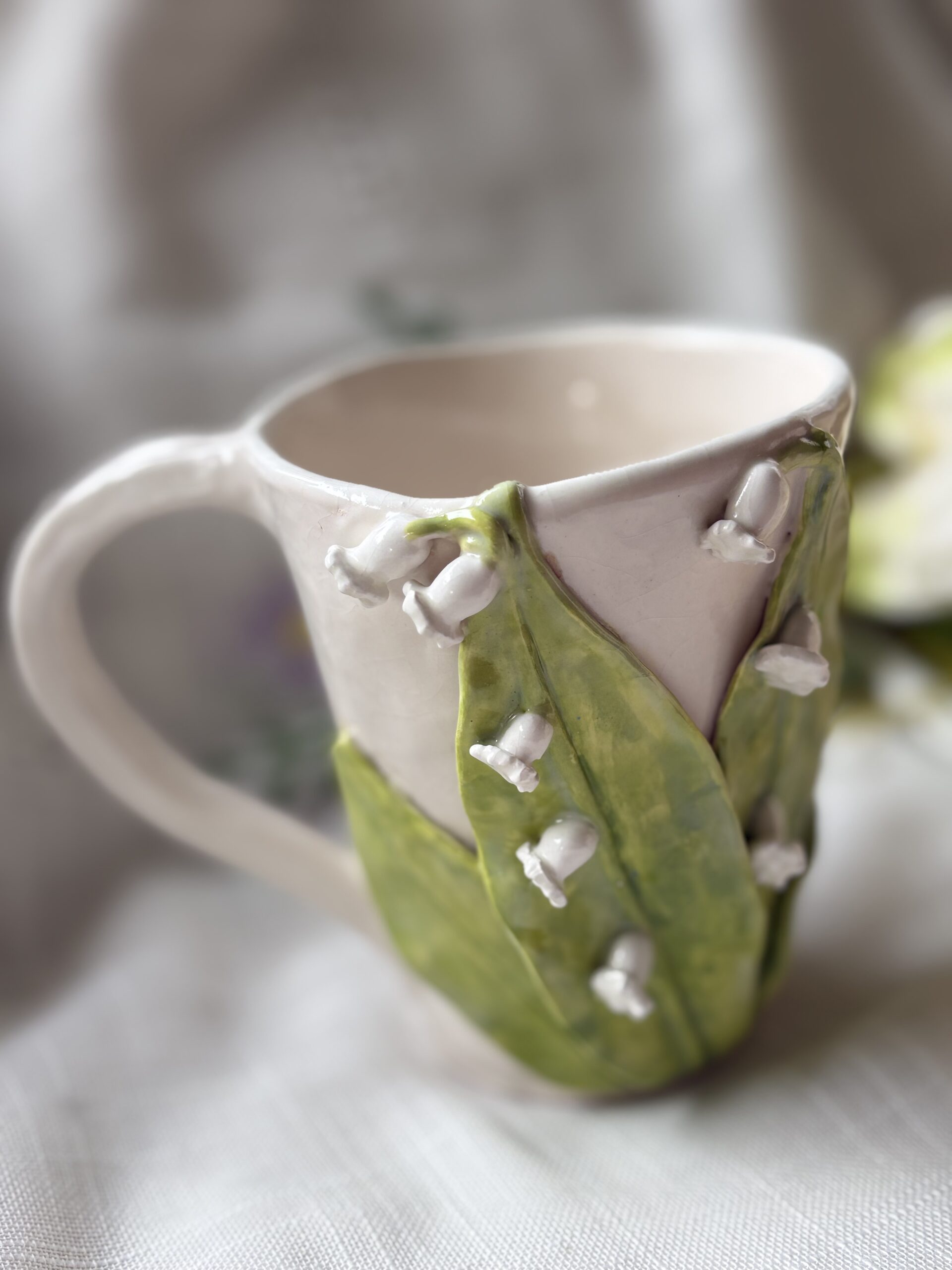 Cup with lily of the valley