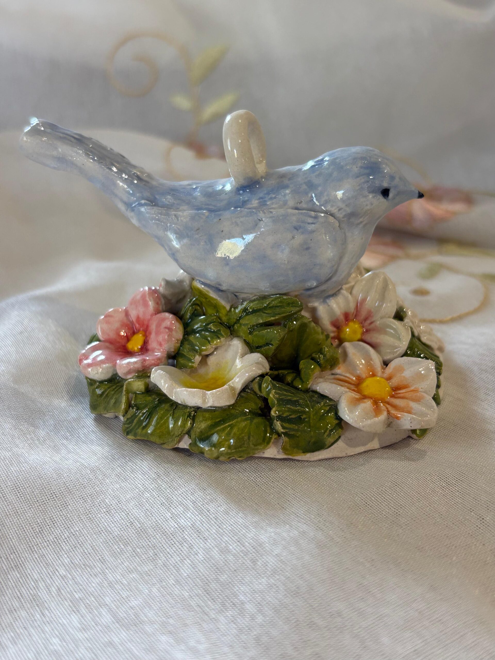 Bird hanging with flowers