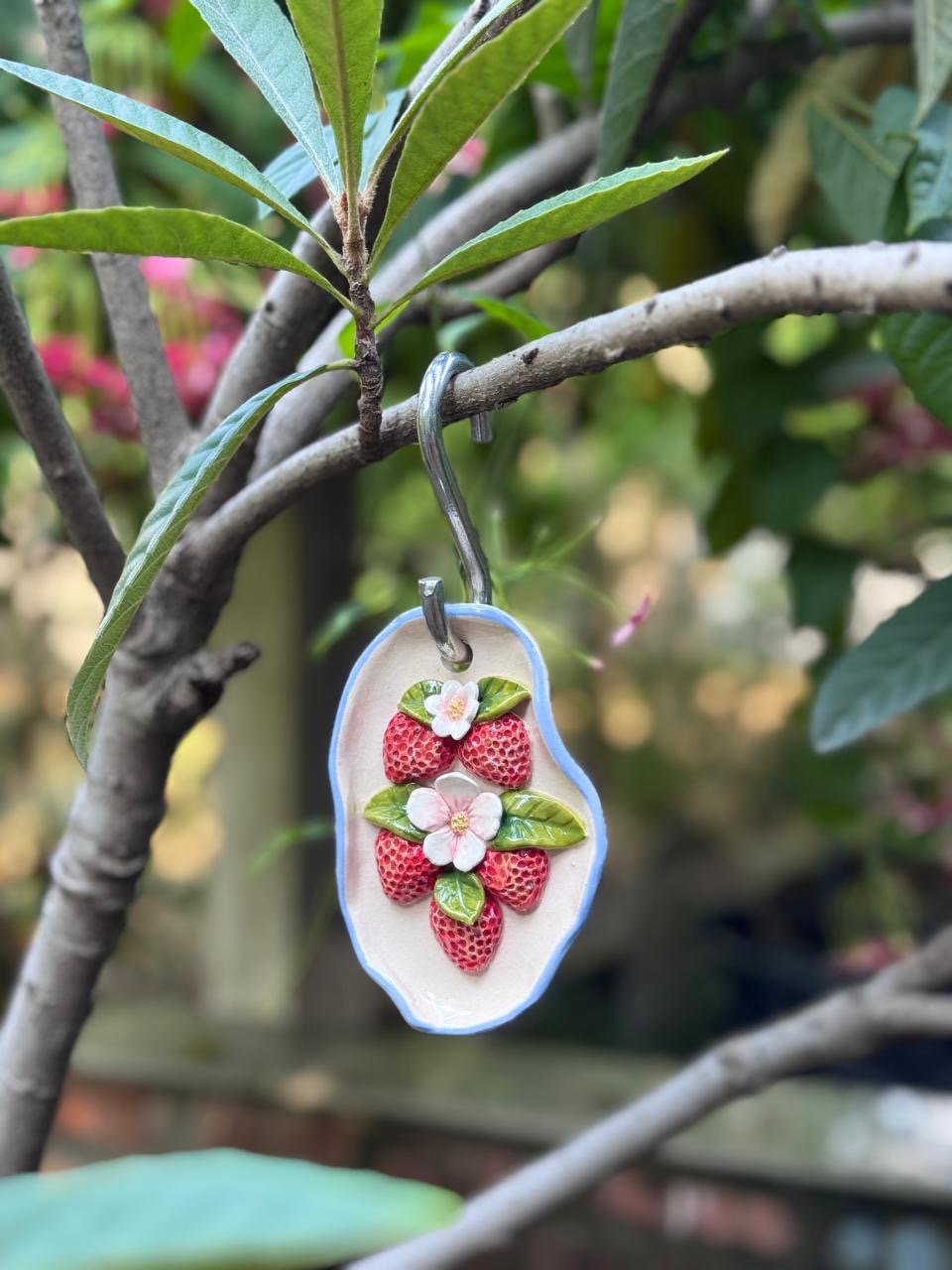 Small strawberry with leaf and flowers